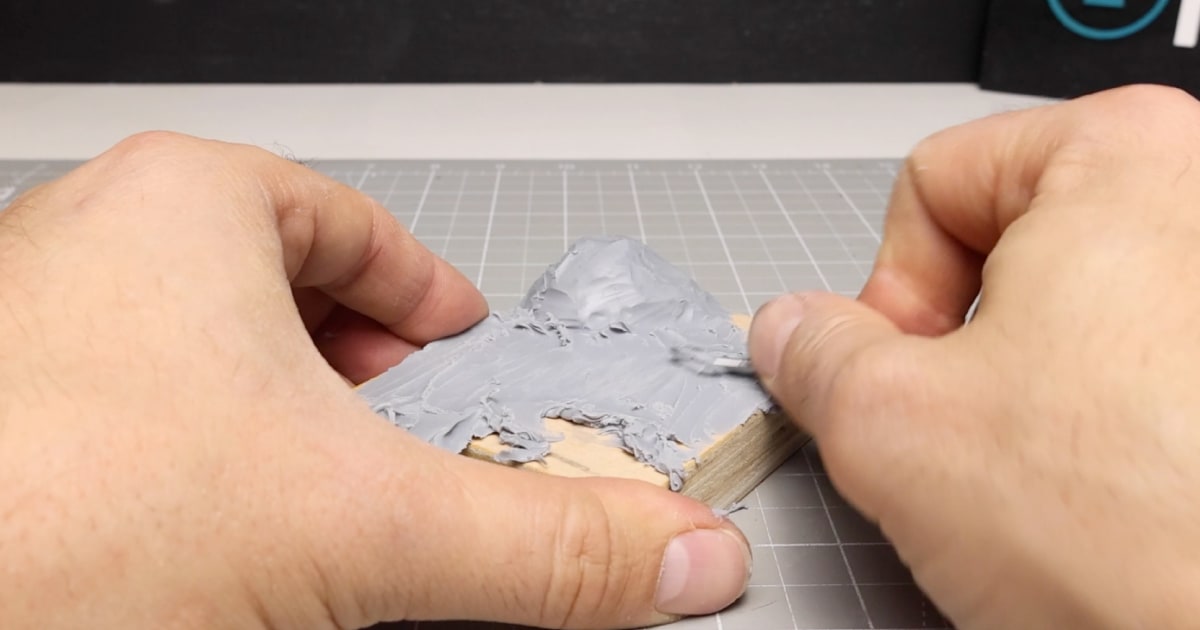 Adding Polymer Clay To The Wooden Base to Form Diorama Floor