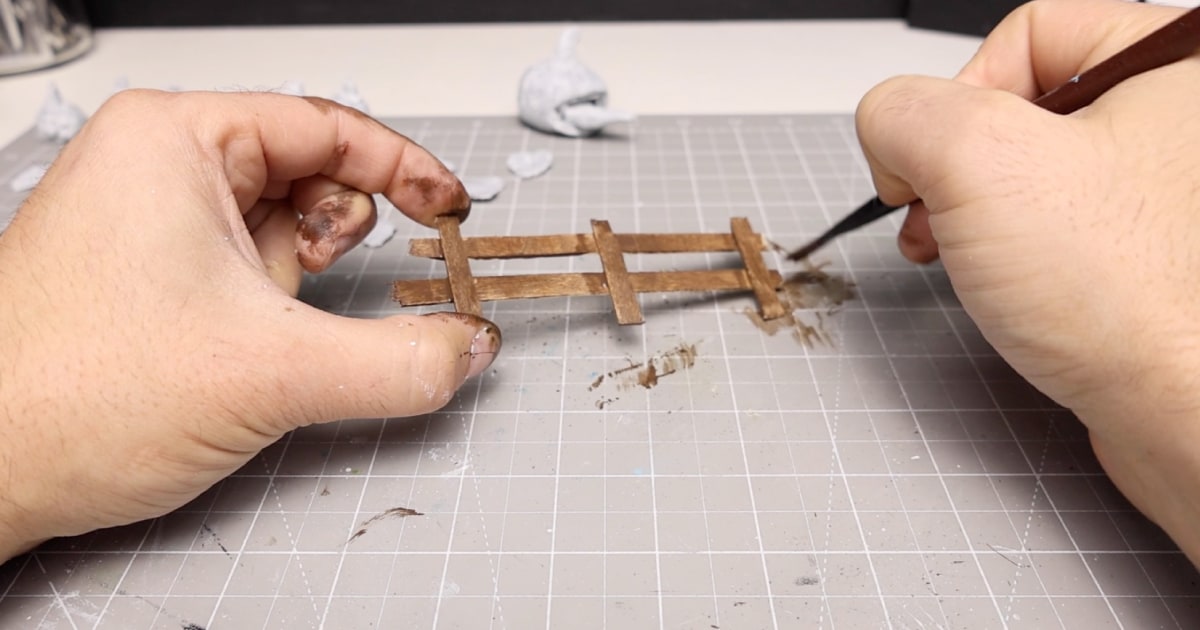 Painting The Pumpkin Patch Fence with Brown Acrylic Wash