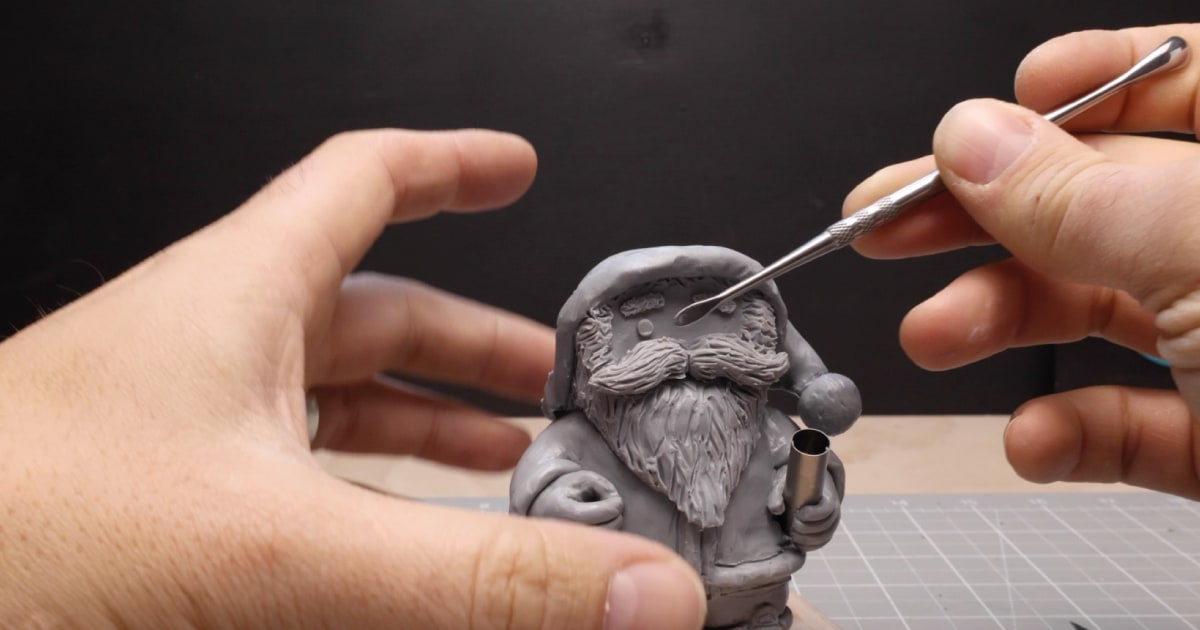 Carefully Adding Eyes To Santa Figurine