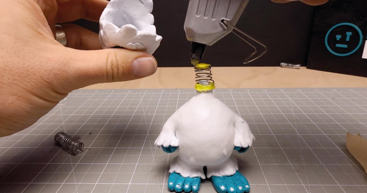 Hot Glueing Custom Spring to Yeti Bobblehead